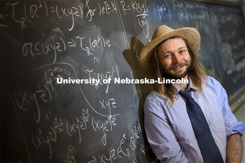 Jack Jeffries, assistant professor of mathematics, is a NSF CAREER winner. On the blackboard are som