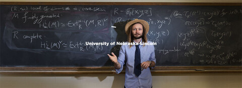 Jack Jeffries, assistant professor of mathematics, is a NSF CAREER winner. On the blackboard are som