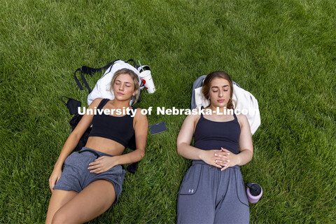 Emily Boyle, right, and Emily Maul, both from Lincoln, enjoy some dead week down time in the greensp