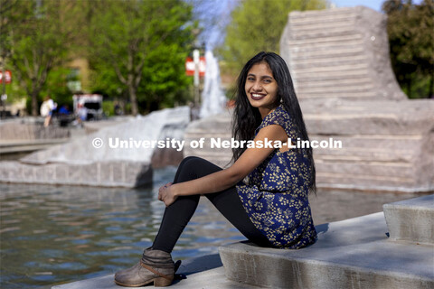 Riha Karney, a Speech-Language Pathologist major, is pictured sitting by the Broyhill fountain outsi