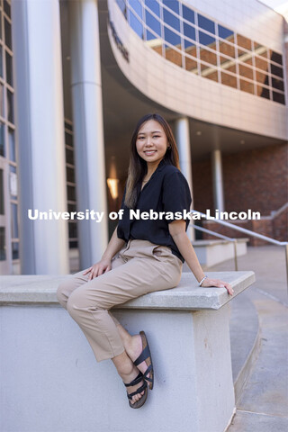 Chau Nguyen for APIDA Heritage Month story. Nguyen poses in front of the Jackie Gaughan Multicultura