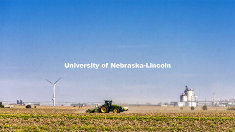 Planting south of Fairmont, Nebraska, with renewable energy in the background. Wind turbines and the