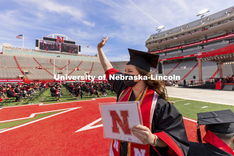 Karlie Sines waves to family and friends after receiving her Fine and Performing Arts degree. UNL Co