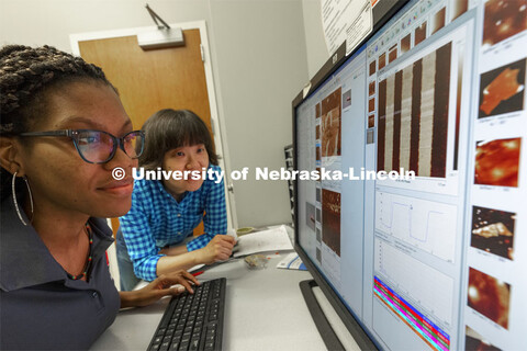 McNair scholar Alyssa Simpson and Professor Xia Hong look over piezoresponse force microscopy images