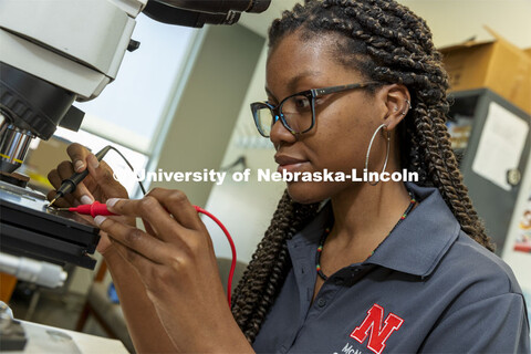 McNair scholar Alyssa Simpson tests a suspended ferroelectric oxide Pb(Zr,Ti)O3 membranes sample to 