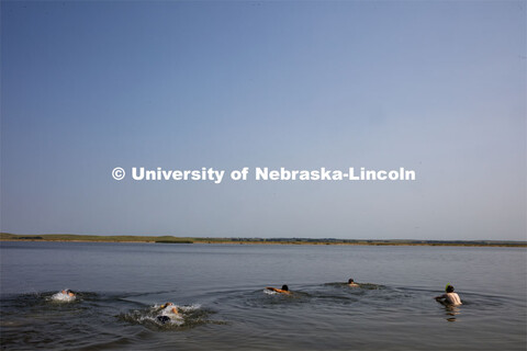 Students dive in Lake Ogallala under the watchful eye of Bill Belcher, assistant professor of anthro