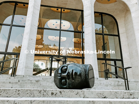 The Fallen Dreamer head sculpture lays on the front steps of the Sheldon Memorial Art Gallery on Cit