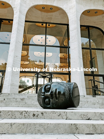 The Fallen Dreamer head sculpture lays on the front steps of the Sheldon Memorial Art Gallery on Cit