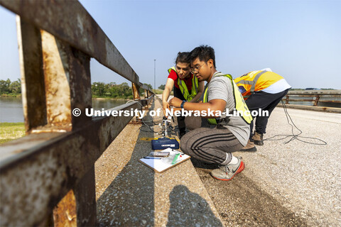 Mitra Nasimi and Awg Ku Ahmad Hashim Bin connect a replacement cable for the bridge sensors before t