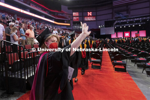 Emma Loberg waves to family and friends as the soon-to-be speech-language pathology masters degree r