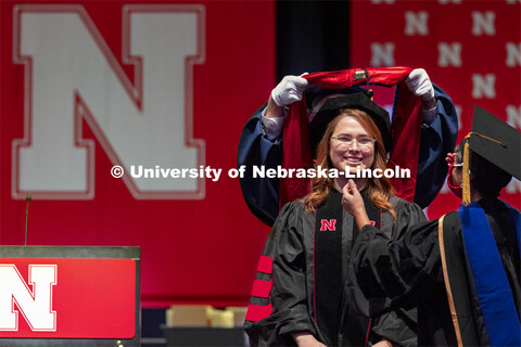 First generation college student and now a doctor in human sciences Ashley Mulcahy Toney smiles as h