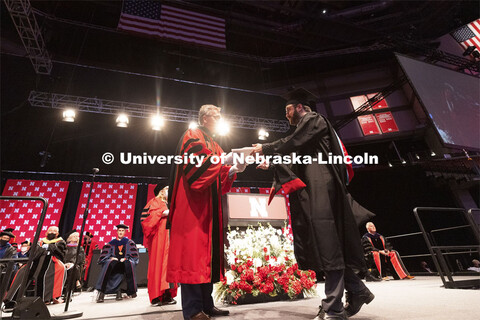 Chancellor Ronnie Green hands out each person’s diploma and talks for a moment with each new gradu