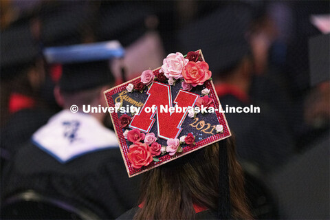 Decorated mortar boards at commencement. Undergraduate Commencement at Pinnacle Bank Arena. August 1