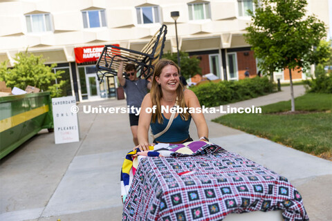 Olivia Price, a First Husker from Papillion, NE, rolls her belongings into Schramm Residence Hall. E