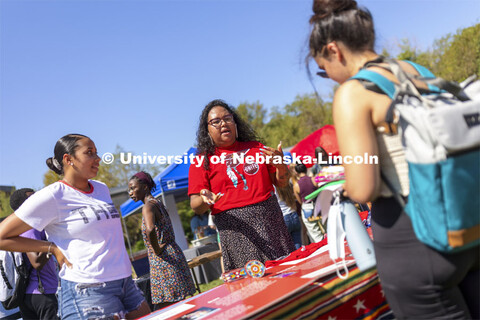 Nasia Olson-White Feather of Red Lake, MN, talks with a student at the UNITE table as Jaicein Mayfie