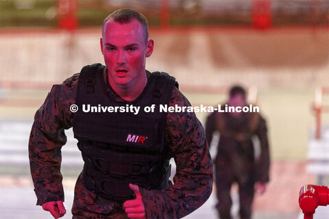 Navy Midshipmen and Marine option ROTC members and cadre run the east stadium steps Thursday morning