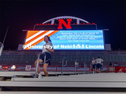 Air Force ROTC members and cadre run the north stadium steps under the video board Thursday morning.