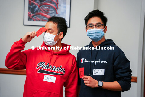 Hung Bui, left, and Hieu Luu hold their cards which put them on the square team for Capture the Baco