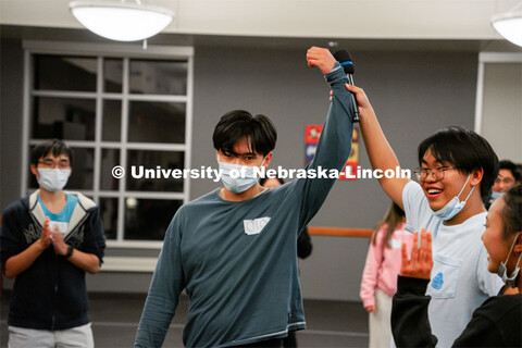 Nam Vo has his arm lifted by Justin Pham after Vo won the Squid Games. Pham made the games and hoste