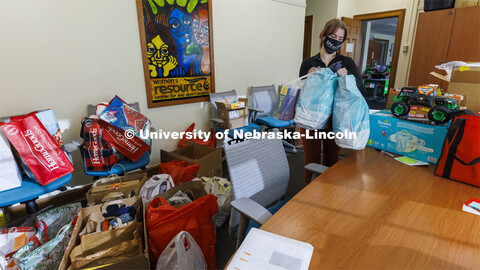 Ashton Koch, senior from Omaha and the outreach coordinator for the Women’s Center, sorts gifts fo