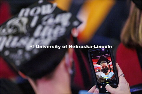 Dara Peters takes a selfie of herself during commencement. Graduate Commencement at Pinnacle Bank Ar