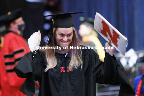 Bonnie Longan celebrates her masters degree as she returns from the stage to her seat. Graduate Comm