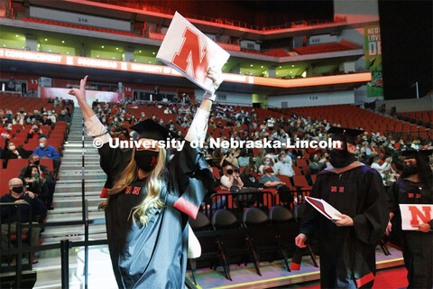 Caitlin Donahue celebrates as the graduates leave the arena. Graduate Commencement at Pinnacle Bank 