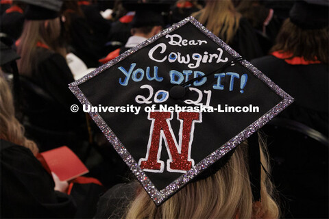 Decorated mortarboards at the Undergraduate Commencement at Pinnacle Bank Arena. December 18, 2021. 