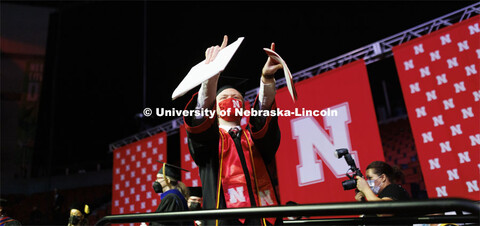 Arts and Sciences graduate Tyler Banark celebrates as he walks off the stage at the Undergraduate Co