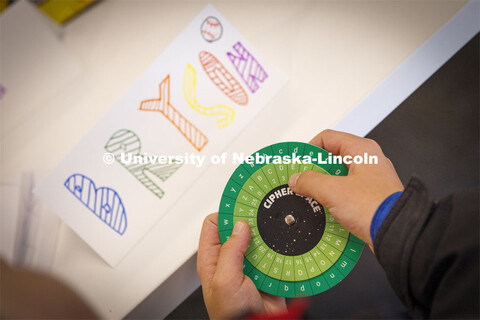 Bryson, 11, works with a cipher wheel during the "Galactic Quest" workshop at Crete Public Library. 