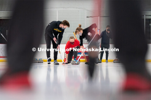 Olivia Schuster serves during curling practice at the John Breslow Ice Hockey Center. Curling Club. 
