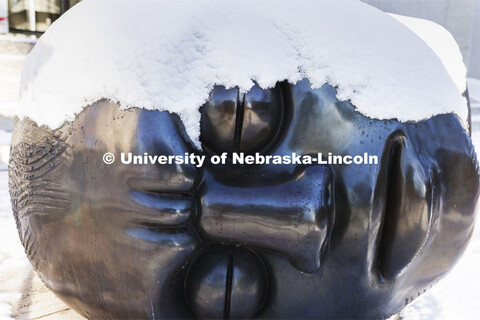 The Fallen Dreamer sculpture is covered with snow. Huskers woke up Monday morning to an inch of snow