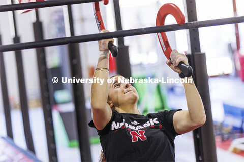 Leigh Jahnke uses hooks to climb bars that slope inward. Jahnke is participating on America Ninja Wa