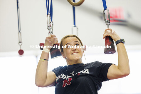 Leigh Jahnke uses “ninja holds” to work her way across the apparatus. Jahnke is participating on