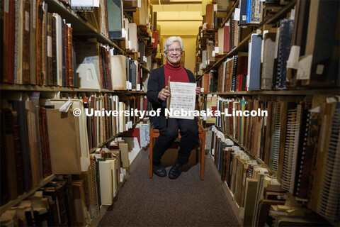 Anita Breckbill, professor, sits amongst the stacks of music. Breckbill oversees the Hixon-Lied Scho