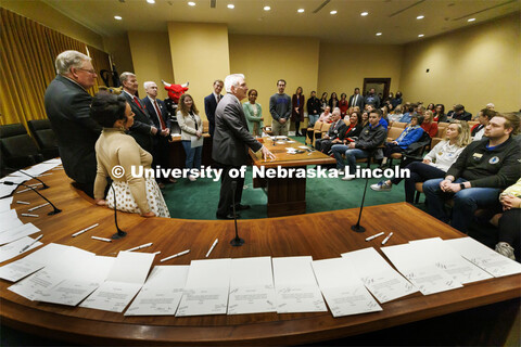 Senator John Stinner talks to the crowd. The table is covered with thank you notes to the senators b