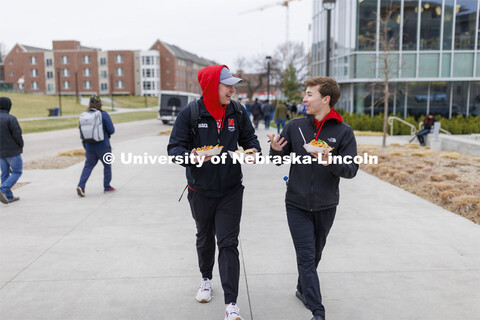 Will Bauer and Luke Skrabal, both freshman from Omaha, head back to their residence halls with food 