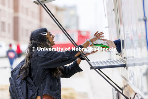 Nandini Rainikindi gets her lunch from the Say Cheese food truck. Students lined up for Food Trucks 