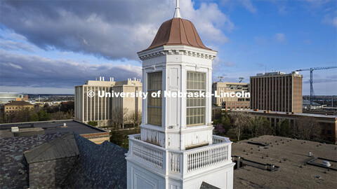 Detail showing chipped paint and water damage to the exterior of the Love Library cupola. The renova