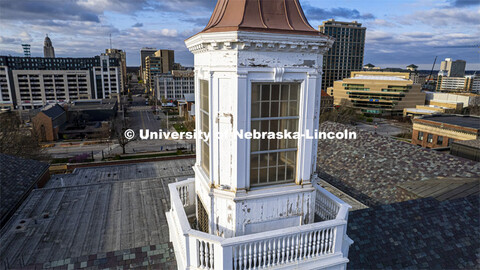 Detail showing chipped paint and water damage to the exterior of the Love Library cupola. The renova