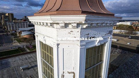 Detail showing chipped paint and water damage to the exterior of the Love Library cupola. The renova