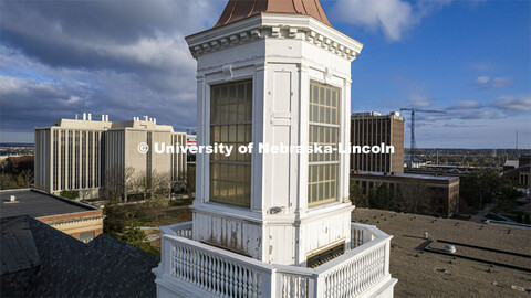 Detail showing chipped paint and water damage to the exterior of the Love Library cupola. The renova