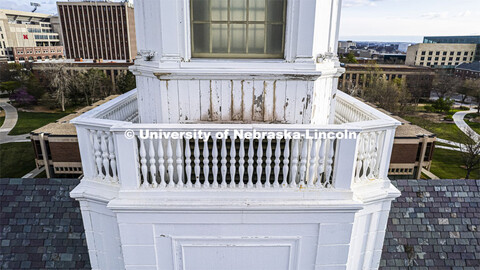 Detail showing chipped paint and water damage to the exterior of the Love Library cupola. The renova