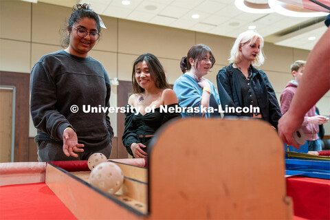 Students play carnival games during the End of Year Bash inside the East Campus Union on Saturday, A