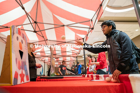Students play carnival games during the End of Year Bash inside the East Campus Union on Saturday, A