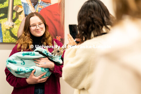Students pet and hold animals during the End of Year Bash inside the East Campus Union on Saturday, 