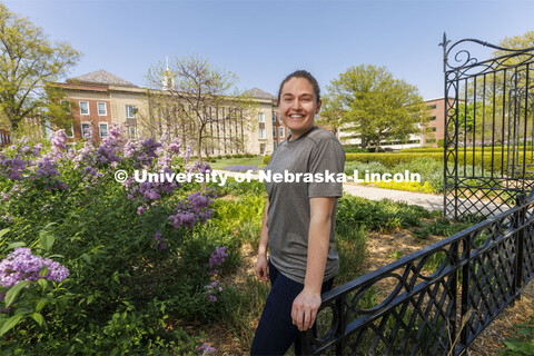 Taylor Daum, a junior English major for ASEM CoCreate story poses in the Love Gardens outside of Lov