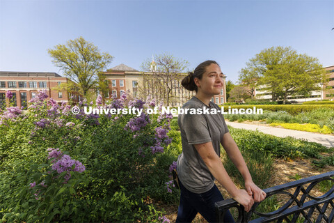 Taylor Daum, a junior English major for ASEM CoCreate story poses in the Love Gardens outside of Lov