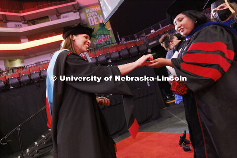 Hooding at graduate commencement in Pinnacle Bank Arena. May 13, 2022. 