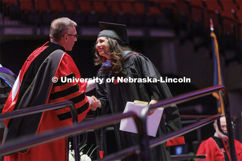 Chancellor Ronnie Green hands out diplomas to grads. Graduate commencement in Pinnacle Bank Arena. M